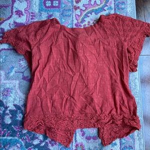 Boutique blouse with lace and open tie back.